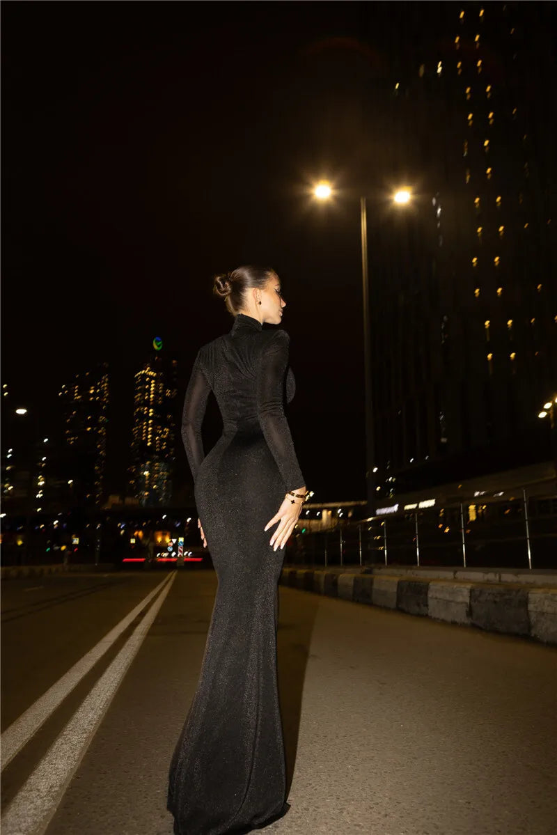 Back View of Mozision Hollow Out Turtleneck Maxi Dress in Black.
