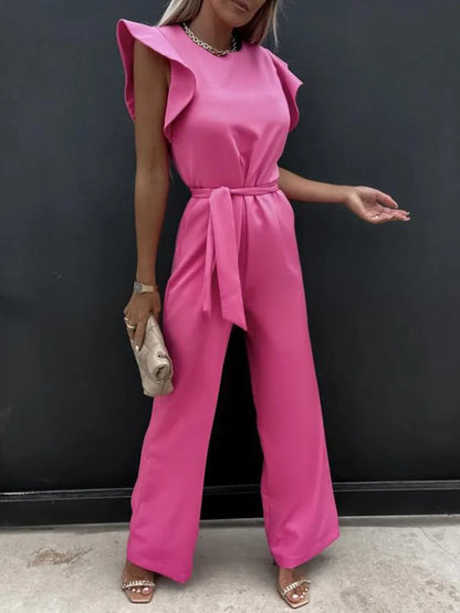 Soft rose-colored jumpsuit, vintage style, featuring a mid-waist and wide-leg pants.
